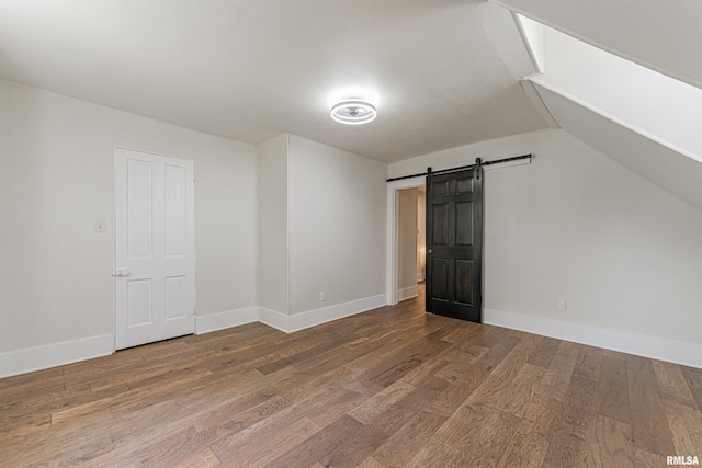 203 Oglesby Ave, Lincoln, IL 62656 - bonus room featuring lofted ceiling, baseboards, wood finished floors, and a barn door