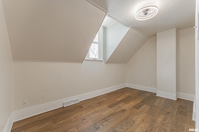 203 Oglesby Ave, Lincoln, IL 62656 - additional living space featuring vaulted ceiling, dark wood-style flooring, visible vents, and baseboards