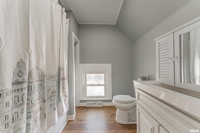 203 Oglesby Ave, Lincoln, IL 62656 - full bathroom with toilet, lofted ceiling, shower / tub combo, wood finished floors, and vanity
