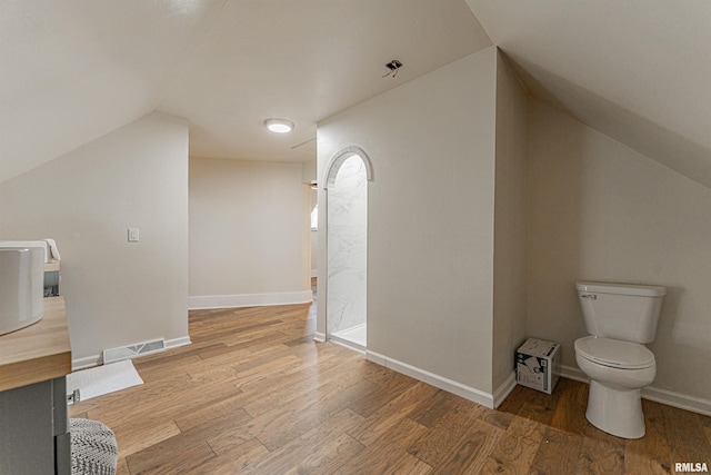 203 Oglesby Ave, Lincoln, IL 62656 - bonus room featuring lofted ceiling, baseboards, visible vents, and light wood-type flooring