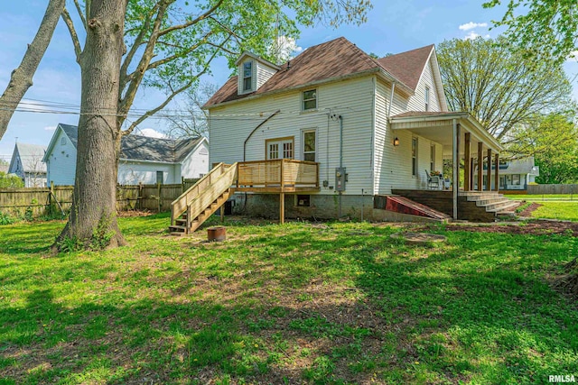 203 Oglesby Ave, Lincoln, IL 62656 - rear view of house featuring a lawn, fence, a deck, and stairs