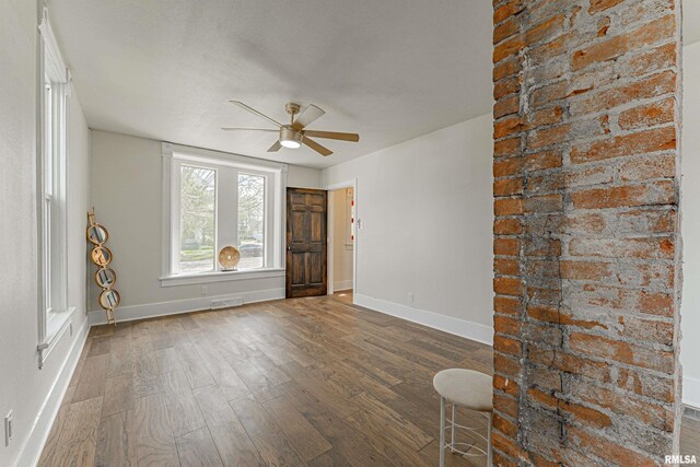 203 Oglesby Ave, Lincoln, IL 62656 - empty room with visible vents, baseboards, ceiling fan, and dark wood finished floors