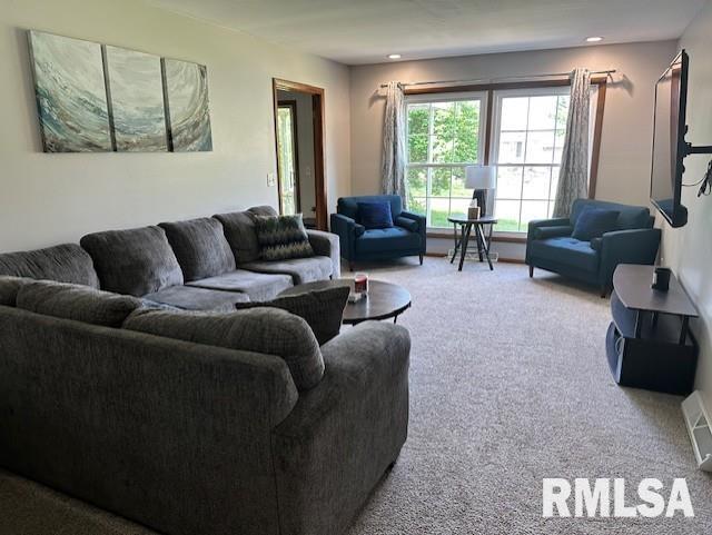 carpeted living area featuring recessed lighting