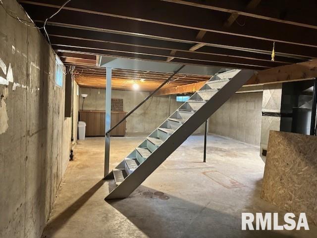 unfinished below grade area featuring stairway