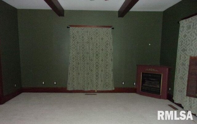 212 Main St, Franklin, IL 62638 - unfurnished living room featuring visible vents, carpet, and beamed ceiling