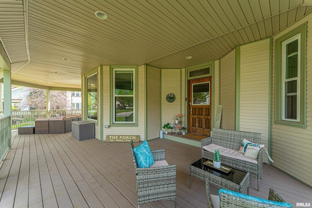 wooden terrace featuring outdoor lounge area and a porch
