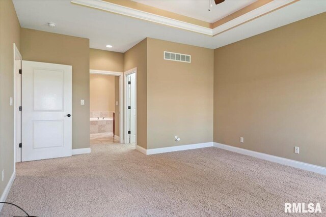 unfurnished room featuring baseboards, visible vents, light carpet, and ceiling fan