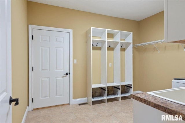 mudroom featuring a sink and baseboards