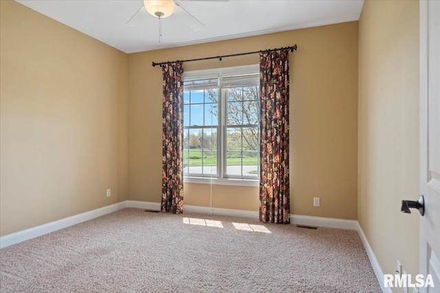empty room with a healthy amount of sunlight, carpet flooring, and baseboards