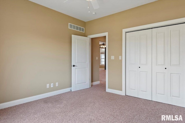 unfurnished bedroom with carpet floors, a closet, ceiling fan, baseboards, and visible vents