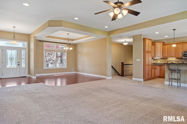 unfurnished living room featuring baseboards, recessed lighting, and light carpet
