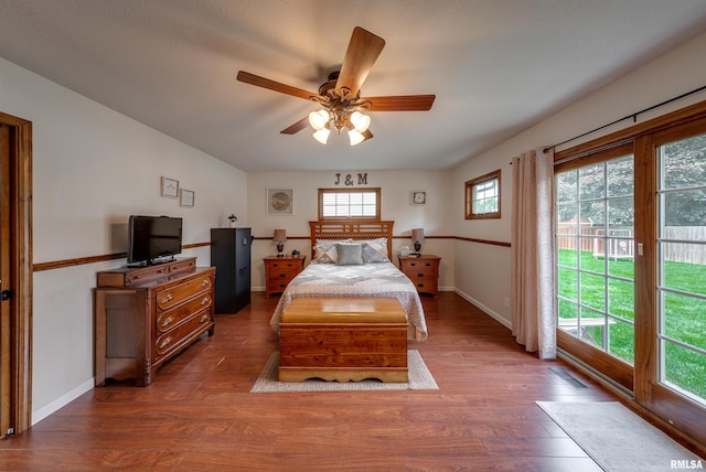 bedroom featuring ceiling fan, access to outside, baseboards, and wood finished floors
