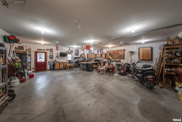 garage featuring a ceiling fan and a workshop area