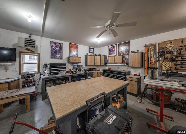 kitchen featuring brown cabinets, light countertops, ceiling fan, and concrete flooring