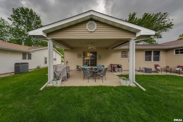 back of house featuring central air condition unit, a patio, a ceiling fan, and a lawn