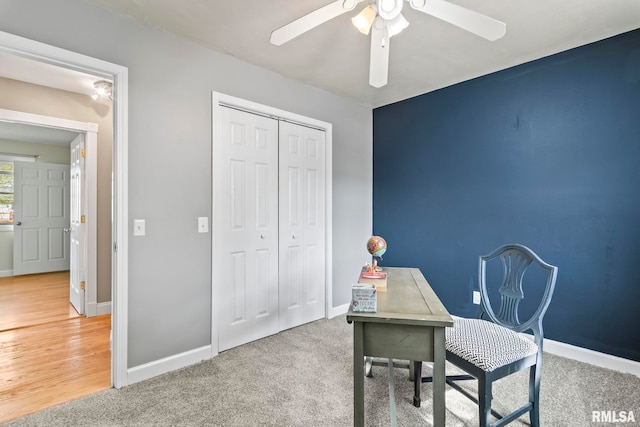 office area with carpet floors, ceiling fan, and baseboards