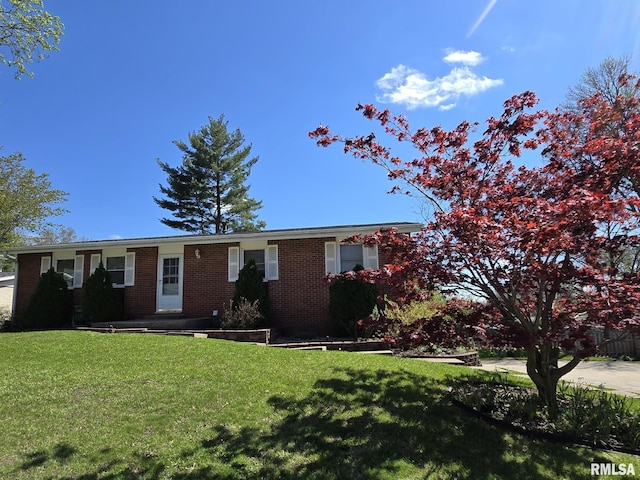 single story home with brick siding and a front lawn