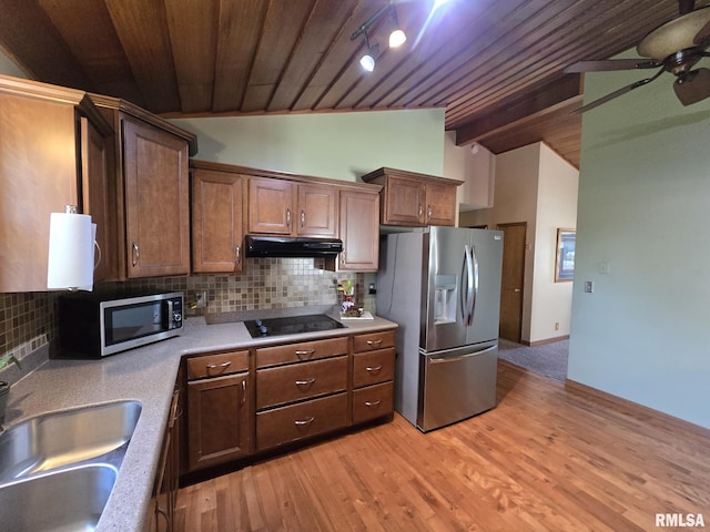 kitchen featuring vaulted ceiling with beams, wood ceiling, stainless steel appliances, under cabinet range hood, and a ceiling fan