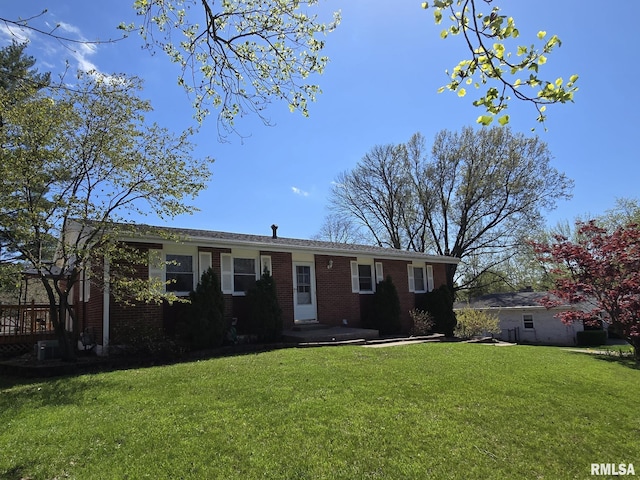 single story home with a front yard and brick siding