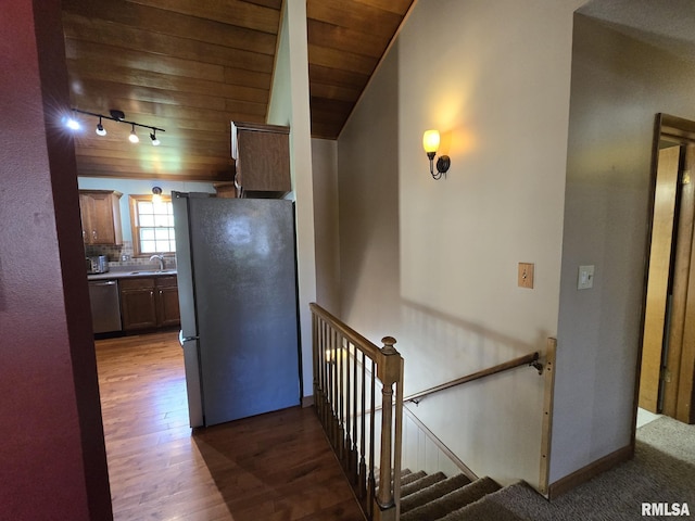 corridor with a sink, wooden ceiling, an upstairs landing, wood finished floors, and lofted ceiling