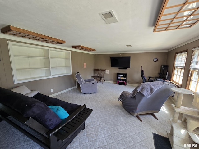 living room featuring baseboards, visible vents, ornamental molding, and carpet flooring