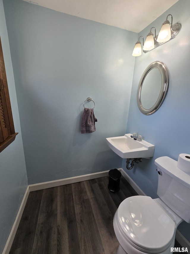 bathroom featuring wood finished floors, toilet, and baseboards