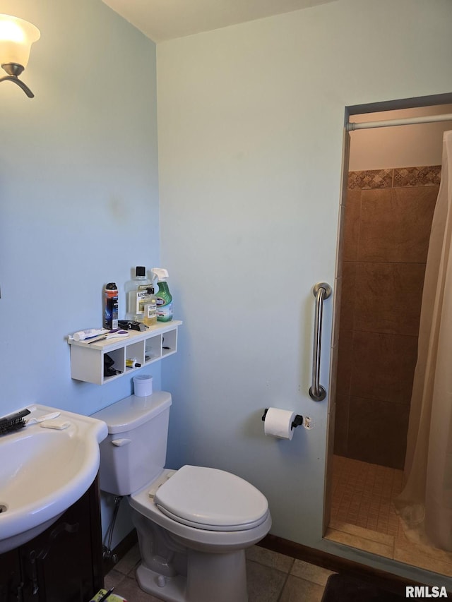 full bath featuring vanity, toilet, a stall shower, baseboards, and tile patterned flooring