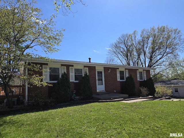 ranch-style home with a front yard and brick siding