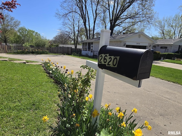 exterior details featuring driveway and fence