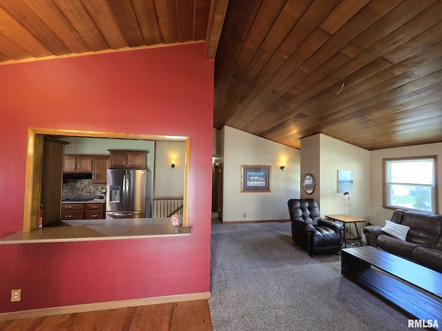 living area with wooden ceiling, vaulted ceiling, and baseboards