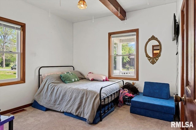 bedroom featuring visible vents, multiple windows, and carpet