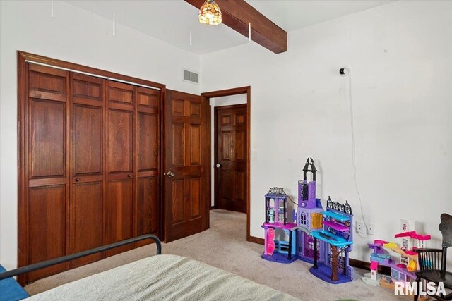 bedroom featuring carpet floors, beamed ceiling, and visible vents