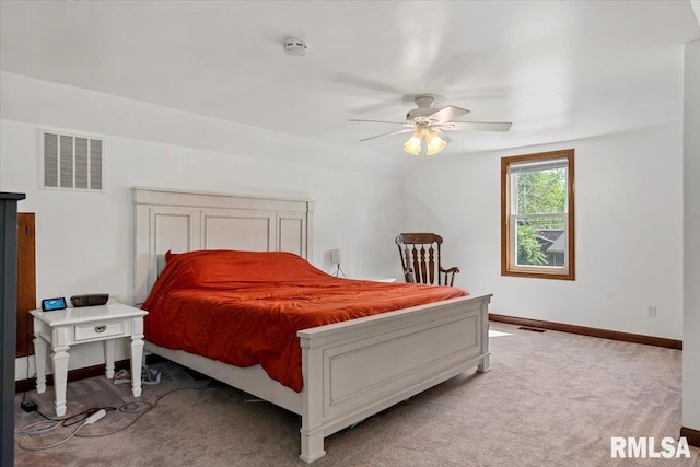 bedroom featuring a ceiling fan, baseboards, visible vents, and light carpet