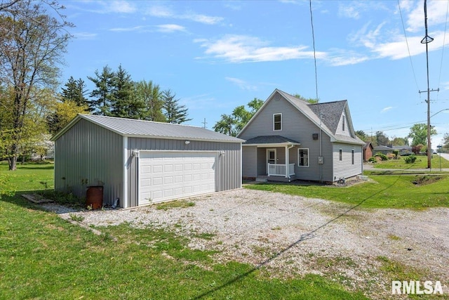 view of front facade with a garage, an outdoor structure, and a front lawn