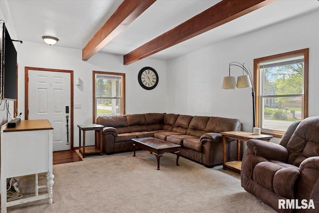 living room featuring light carpet, beam ceiling, and a wealth of natural light