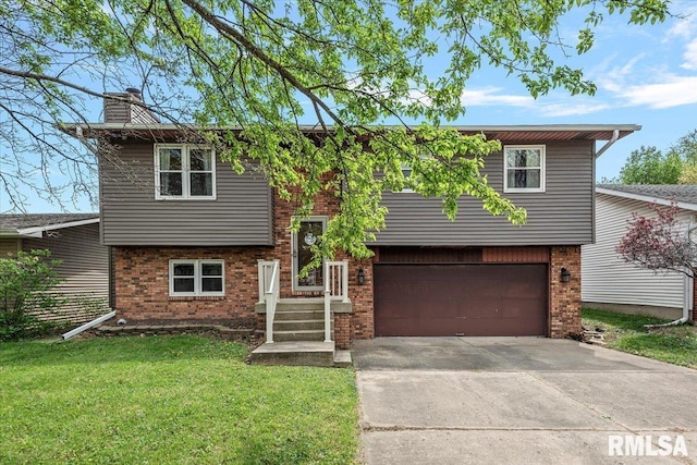 raised ranch with a front lawn, a garage, brick siding, a chimney, and concrete driveway