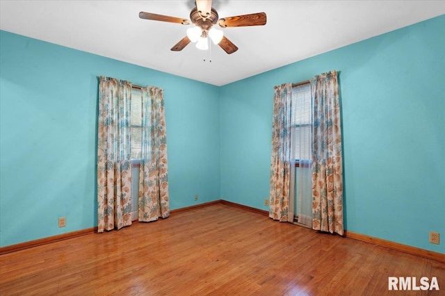 unfurnished room featuring baseboards, ceiling fan, plenty of natural light, and wood finished floors