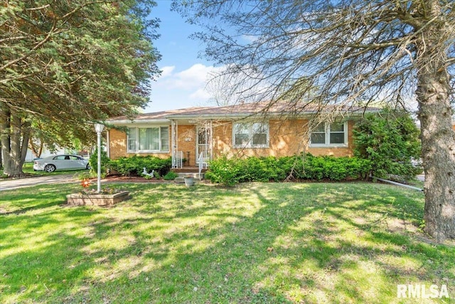 single story home featuring brick siding and a front lawn