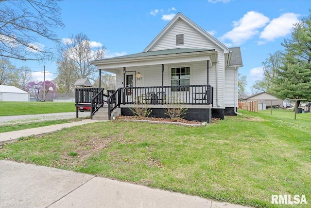 view of front of property with covered porch and a front lawn