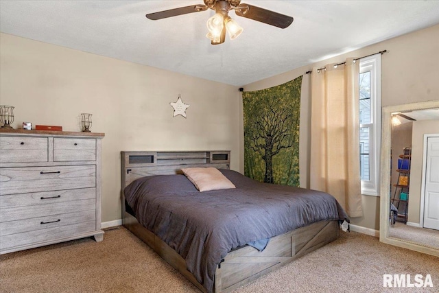 bedroom with baseboards, a ceiling fan, and light colored carpet