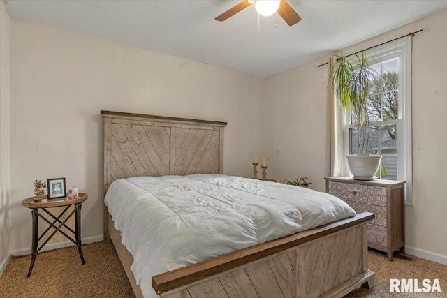 bedroom featuring baseboards, light carpet, and ceiling fan