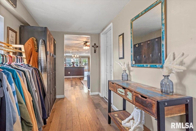 hall with hardwood / wood-style floors and baseboards