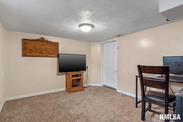 office area with light colored carpet, visible vents, baseboards, and a textured ceiling