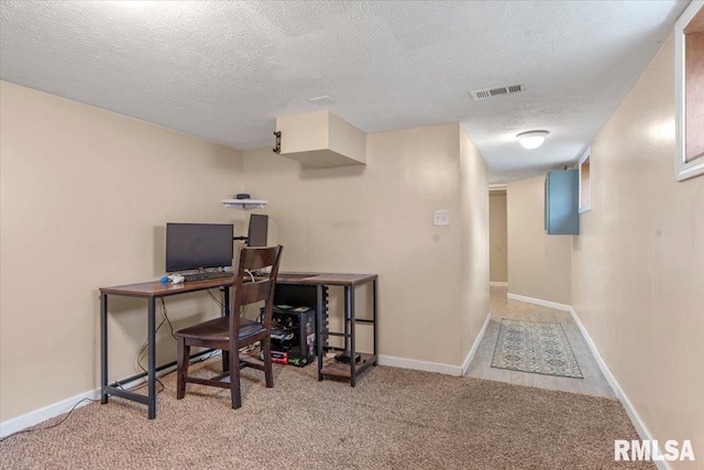 carpeted office space featuring a textured ceiling, visible vents, and baseboards