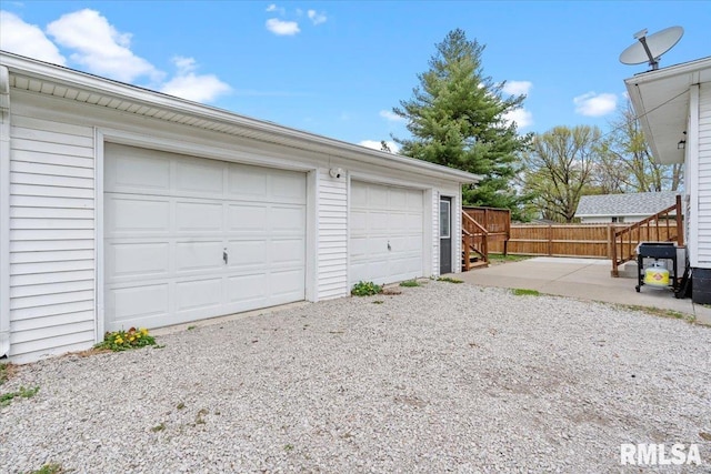 detached garage featuring fence