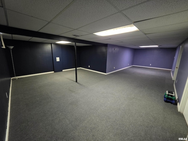 finished basement with a drop ceiling, carpet floors, and baseboards