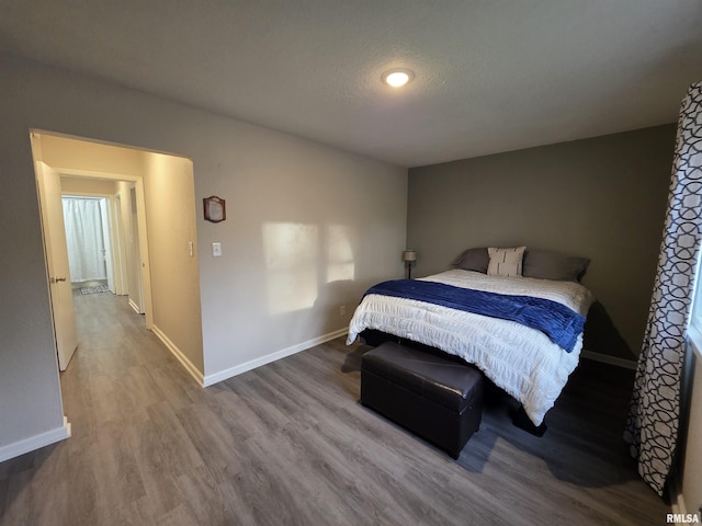 bedroom with wood finished floors and baseboards