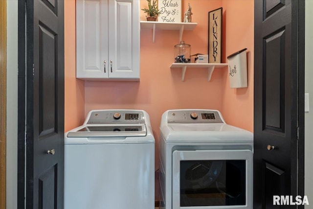 washroom with cabinet space and washing machine and dryer