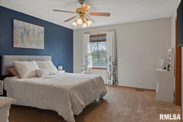 carpeted bedroom featuring baseboards and ceiling fan