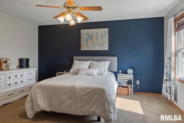 bedroom featuring carpet floors, baseboards, and ceiling fan